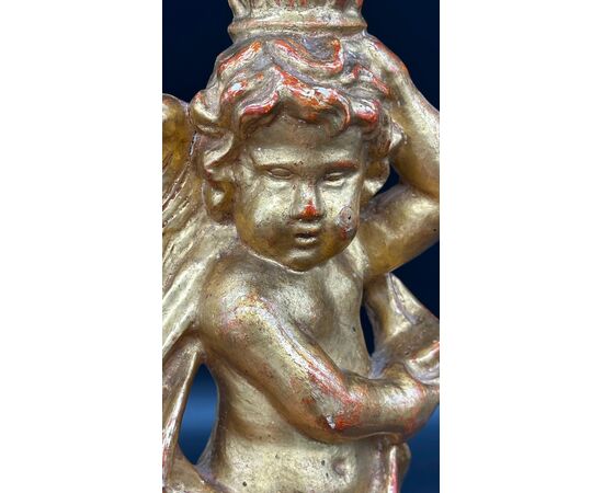 Carved and gilded wooden candlestick with cherub figure - 18th century.