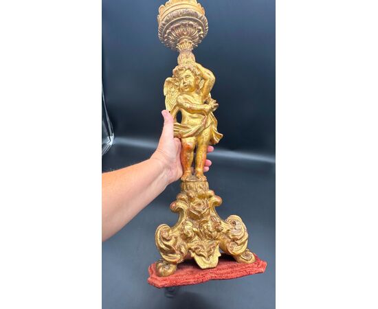 Carved and gilded wooden candlestick with cherub figure - 18th century.