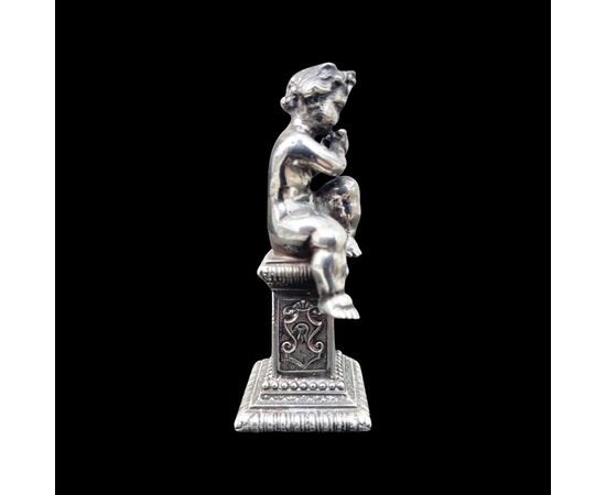 Small solid silver sculpture depicting a musical child. Italy.