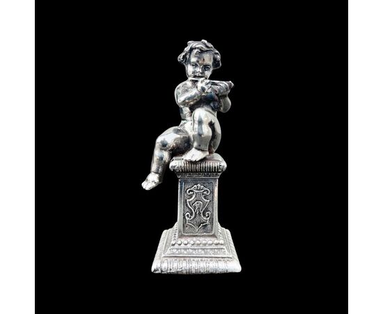 Small solid silver sculpture depicting a musical child. Italy.