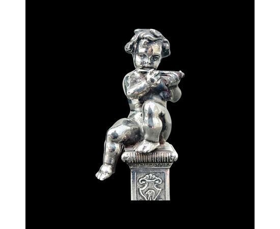 Small solid silver sculpture depicting a musical child. Italy.