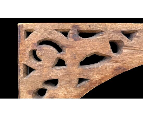 Carved wooden overdoor frieze with a scroll leaf motif.