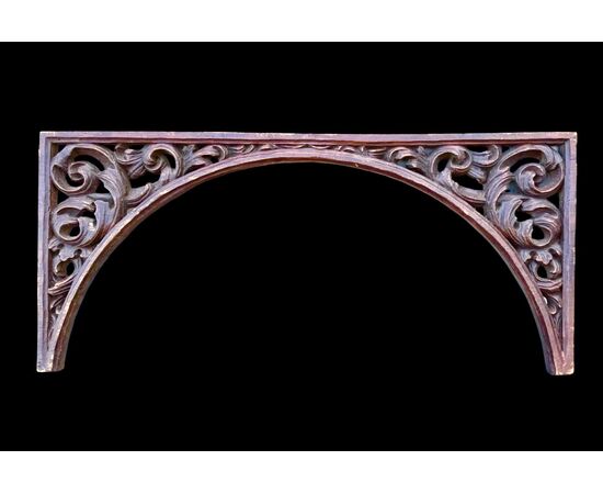 Carved wooden overdoor frieze with a scroll leaf motif.