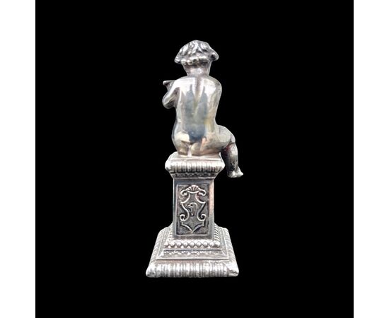 Small solid silver sculpture depicting a musical child. Italy.