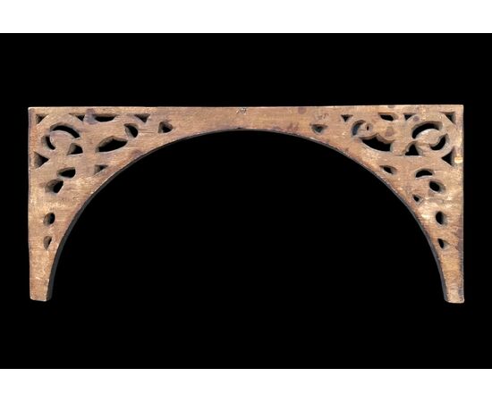 Carved wooden overdoor frieze with a scroll leaf motif.