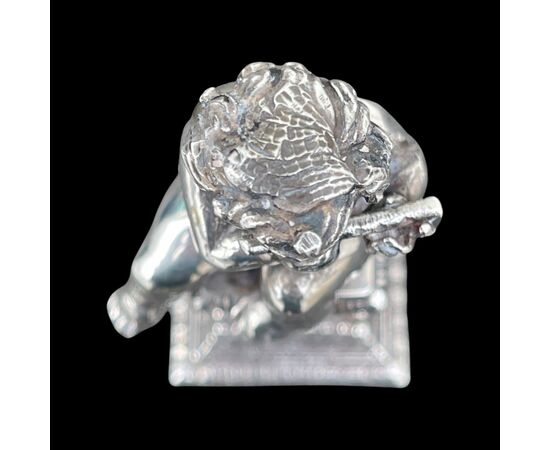 Small solid silver sculpture depicting a musical child. Italy.