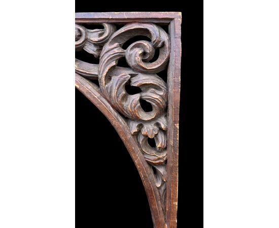 Carved wooden overdoor frieze with a scroll leaf motif.