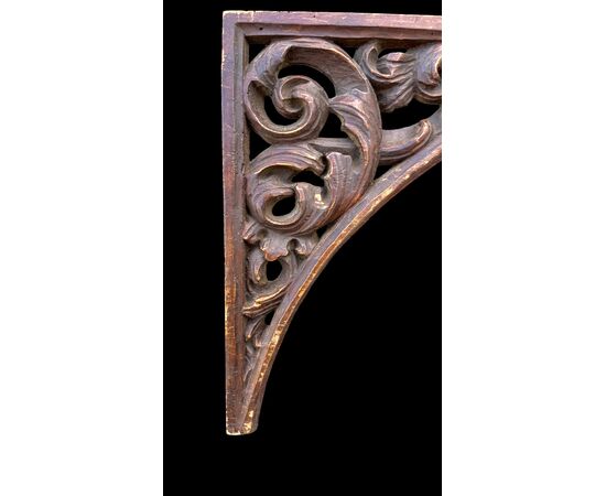 Carved wooden overdoor frieze with a scroll leaf motif.