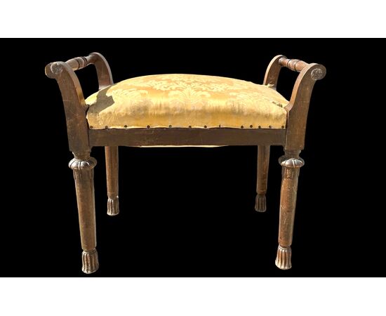 Walnut bench with grips and turned legs with geometric patterns.