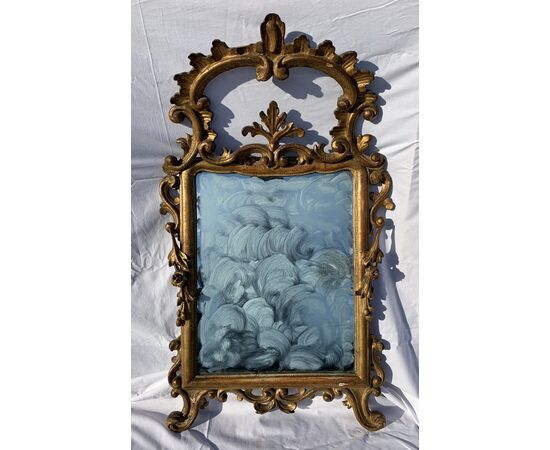 Carved and gilded wooden mirror. Italy, 18th century.