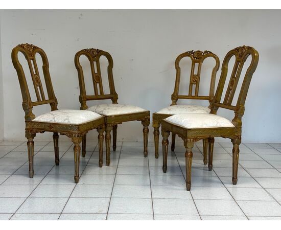 Group of four Louis XVI lacquered and gilded chairs. 18th century. Restored.