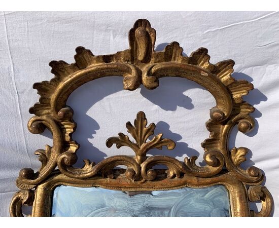 Carved and gilded wooden mirror. Italy, 18th century.