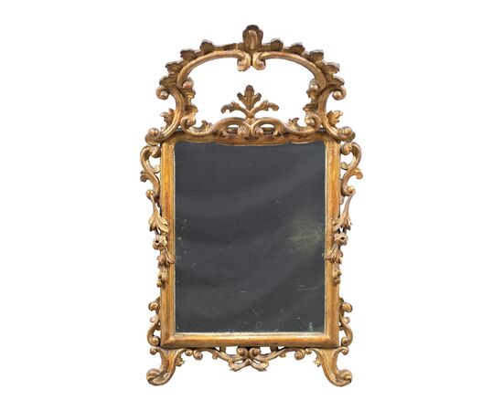 Carved and gilded wooden mirror. Italy, 18th century.