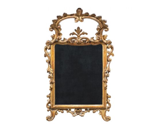 Carved and gilded wooden mirror. Italy, 18th century.