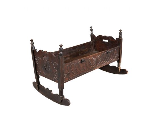 Carved wooden cradle. Italy, 19th century.