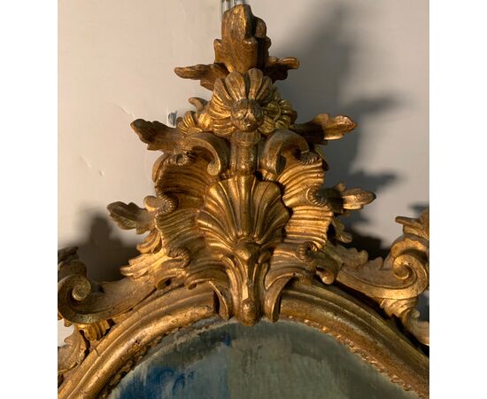 Carved and gilded wooden mirror. Northern Italy, 18th century.