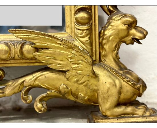 Carved and gilded wooden mirror. Tuscany, early 19th century.