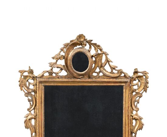 Carved and gilded wooden mirror. Venice, 18th century.
