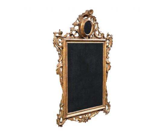 Carved and gilded wooden mirror. Venice, 18th century.