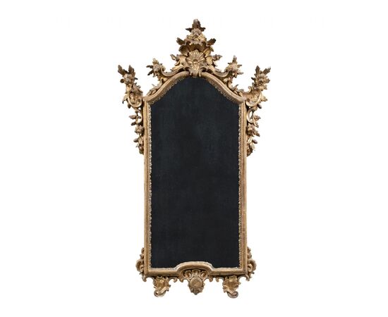 Carved and gilded wooden mirror. Northern Italy, 18th century.