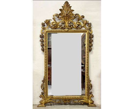 Carved and gilded wooden mirror. Tuscany, early 19th century.