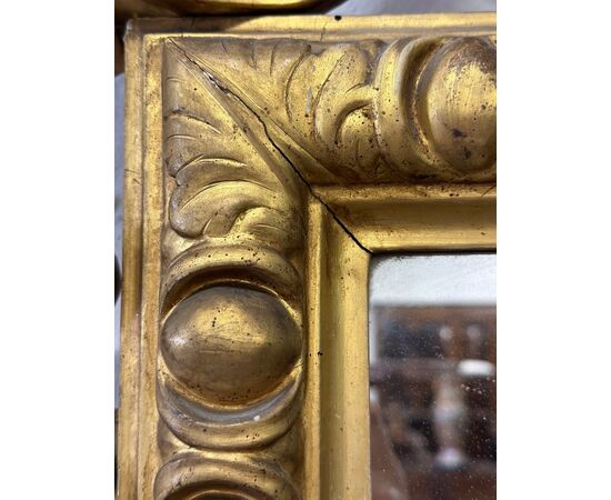 Carved and gilded wooden mirror. Tuscany, early 19th century.