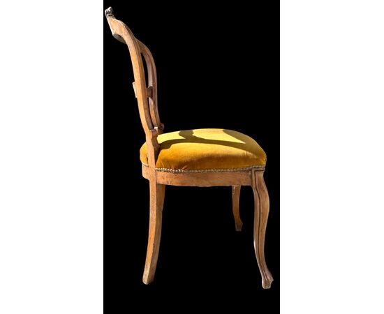 Four walnut chairs carved with rocaille motifs.