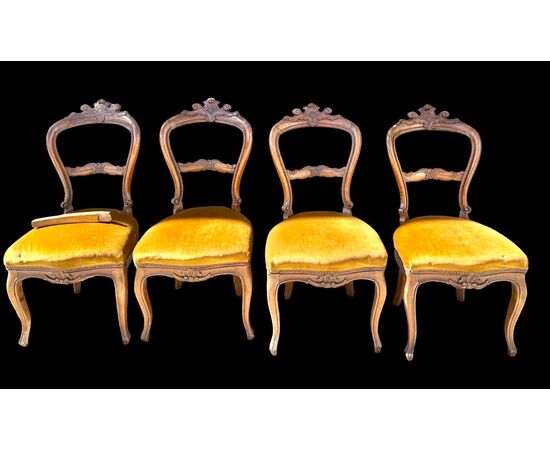 Four walnut chairs carved with rocaille motifs.