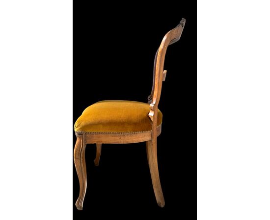 Four walnut chairs carved with rocaille motifs.