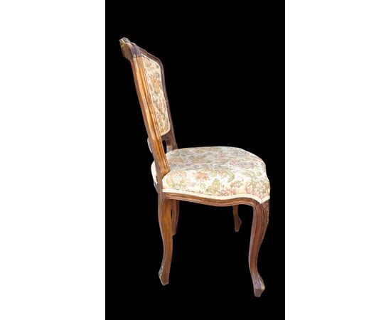 Four walnut chairs with floral pattern carvings.