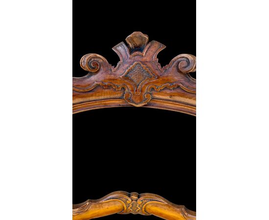 Four walnut chairs carved with rocaille motifs.