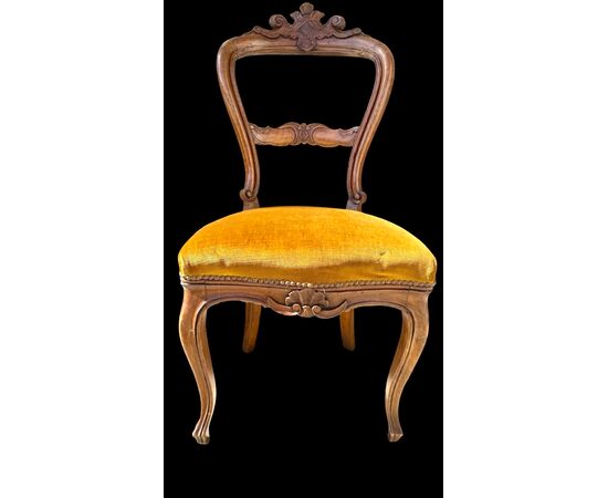Four walnut chairs carved with rocaille motifs.