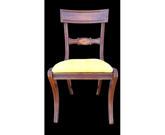 Four walnut chairs with geometric pattern decoration.