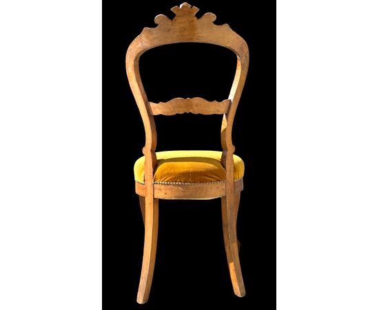 Four walnut chairs carved with rocaille motifs.