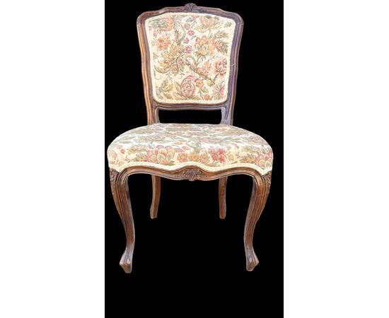 Four walnut chairs with floral pattern carvings.