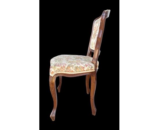 Four walnut chairs with floral pattern carvings.