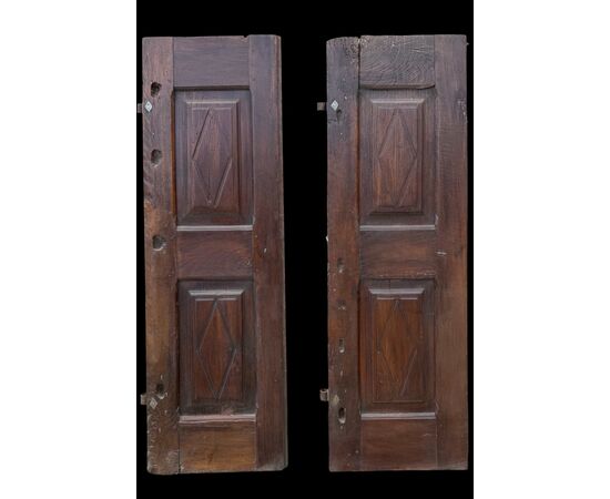 Pair of walnut doors with four engraved diamond panels.