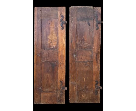 Pair of walnut doors with four engraved diamond panels.