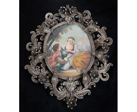 Hand-painted plaque depicting a gallant scene with a silver filigree frame. Rome, 18th century.