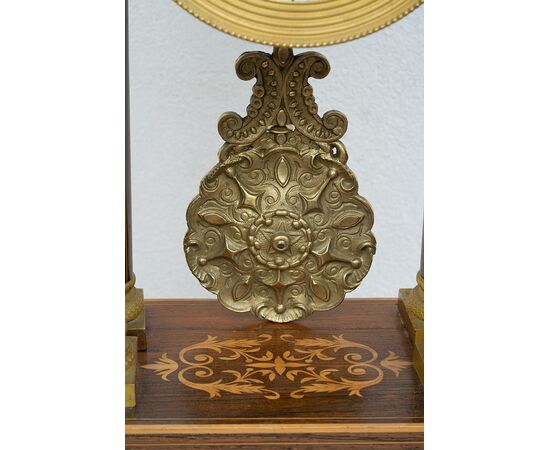 Antique Charles X clock in precious exotic woods. France, 19th century.