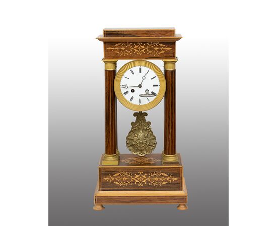 Antique Charles X clock in precious exotic woods. France, 19th century.