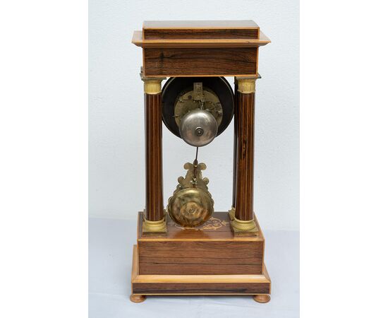 Antique Charles X clock in precious exotic woods. France, 19th century.