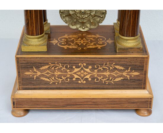 Antique Charles X clock in precious exotic woods. France, 19th century.