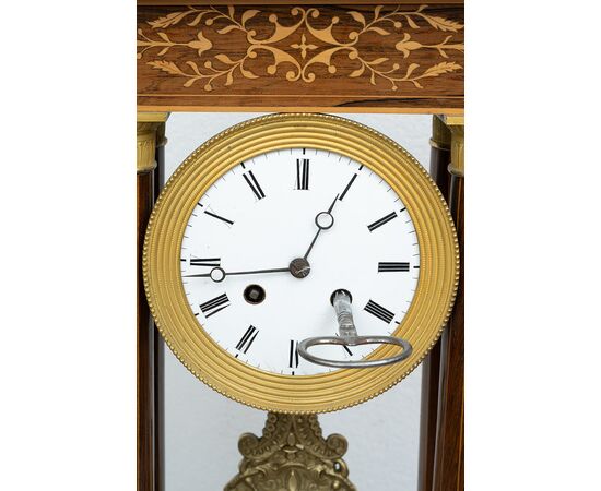 Antique Charles X clock in precious exotic woods. France, 19th century.