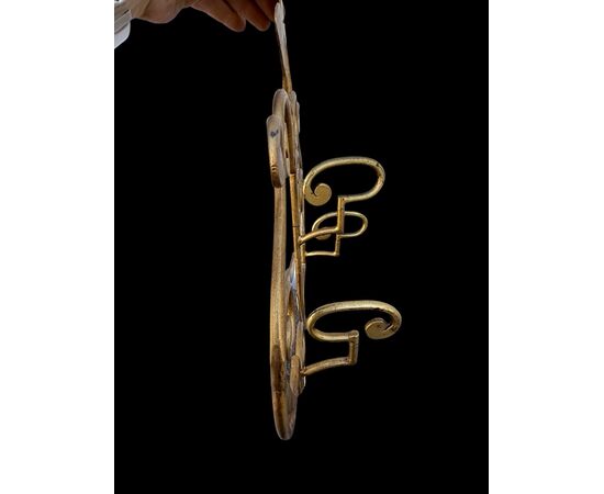Wrought iron and gilded coat rack wall light.