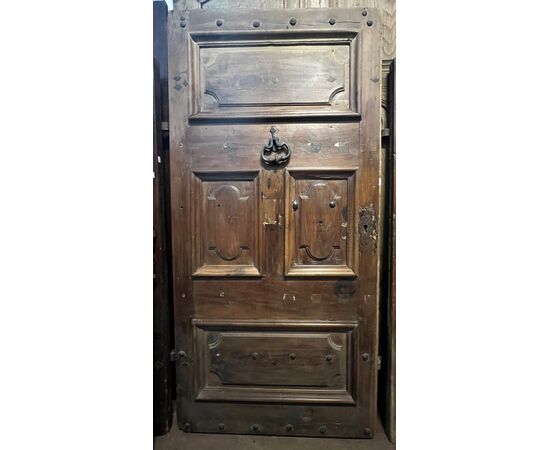 PTCI474 - Studded small door, with sculpted panels, in walnut wood, 18th century, measurements cm W 114 x H 238