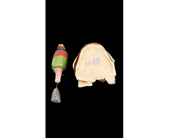 Ceramic figure depicting a Japanese character. Articulated head.