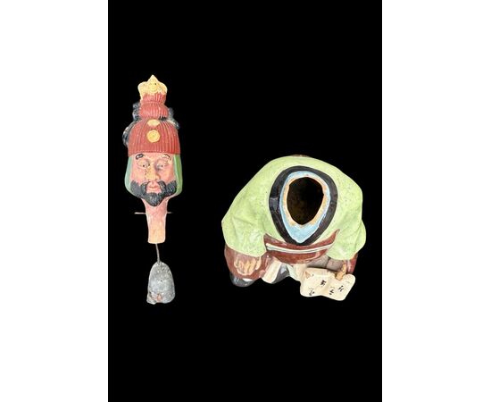Ceramic figure depicting a Japanese character. Articulated head.