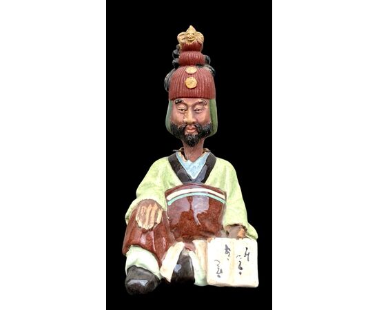 Ceramic figure depicting a Japanese character. Articulated head.