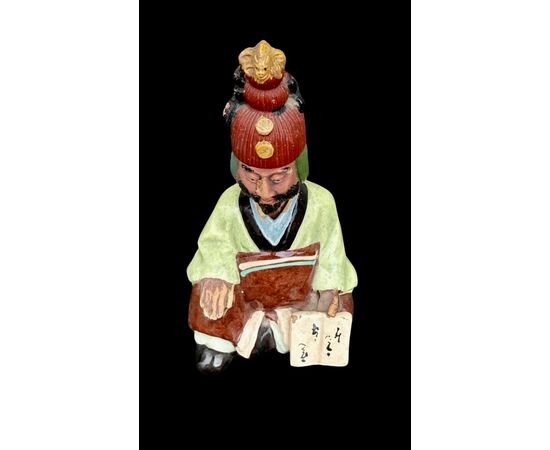 Ceramic figure depicting a Japanese character. Articulated head.